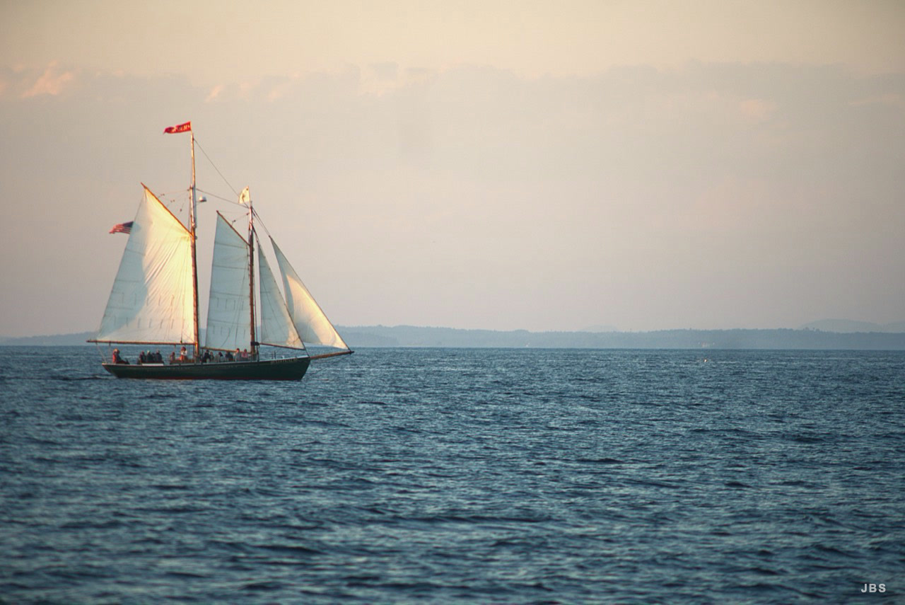 A schooner under full sail across open water