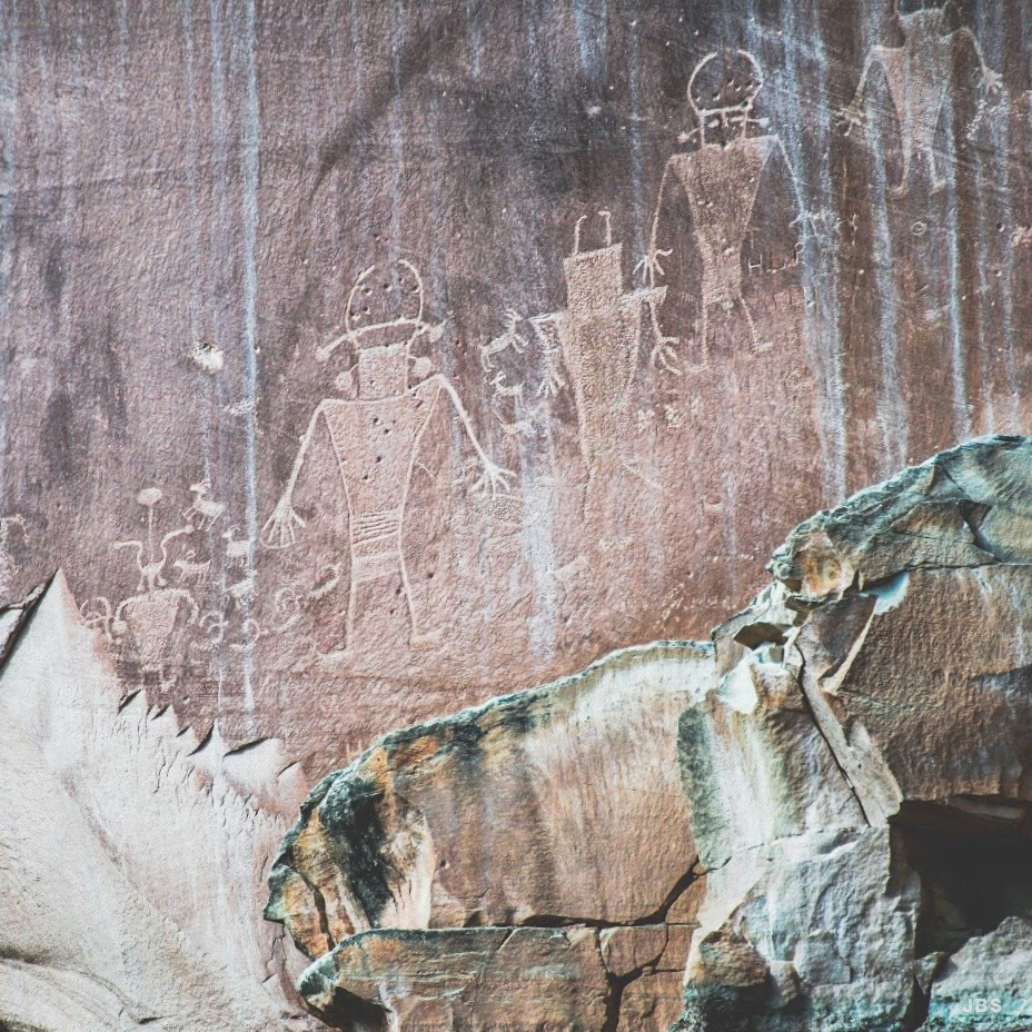 Ancient figures carved into a sandstone wall